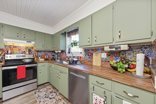 kitchen featuring stainless steel appliances, green cabinets, wooden counters, light hardwood / wood-style floors, and ornamental molding