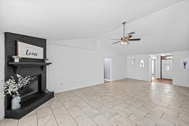 living room with a textured ceiling, a brick fireplace, ceiling fan, and lofted ceiling