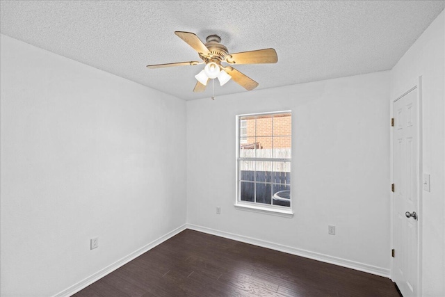 empty room featuring a textured ceiling, ceiling fan, and dark wood-type flooring