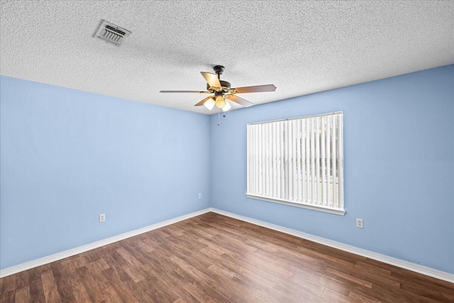 empty room featuring ceiling fan, a textured ceiling, and hardwood / wood-style flooring