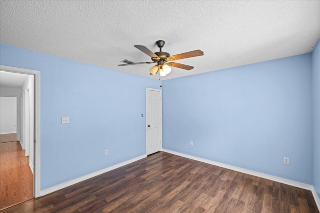 empty room with a textured ceiling, ceiling fan, and dark wood-type flooring