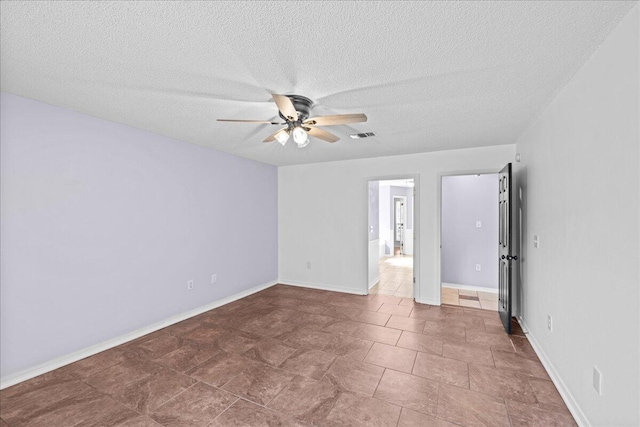 spare room featuring a textured ceiling and ceiling fan