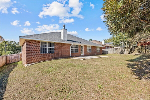 back of house featuring a yard and a patio