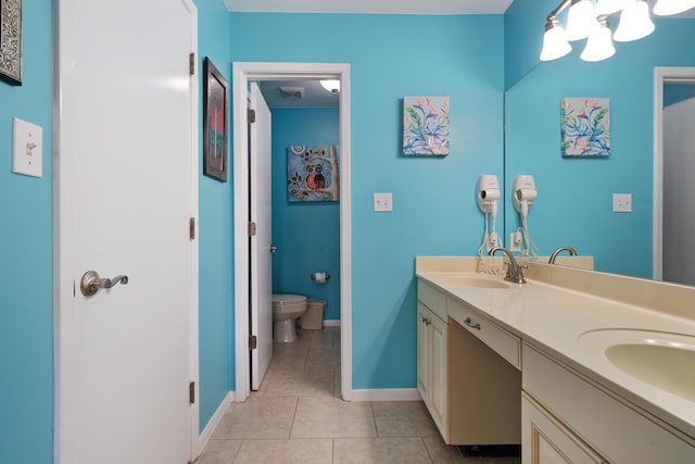 bathroom featuring toilet, vanity, and tile patterned floors