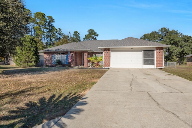 ranch-style house featuring a garage and a front lawn