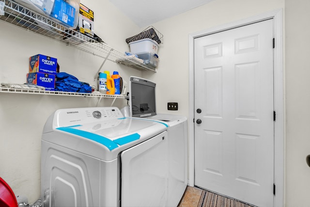 clothes washing area featuring washer and dryer