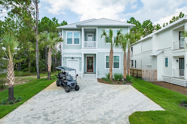 view of front of house featuring a garage and a front lawn