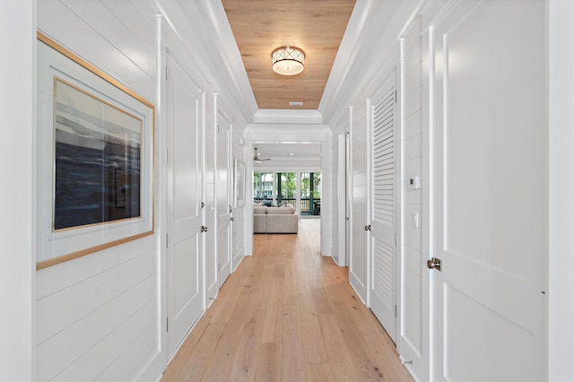 hallway featuring light hardwood / wood-style floors and wooden ceiling