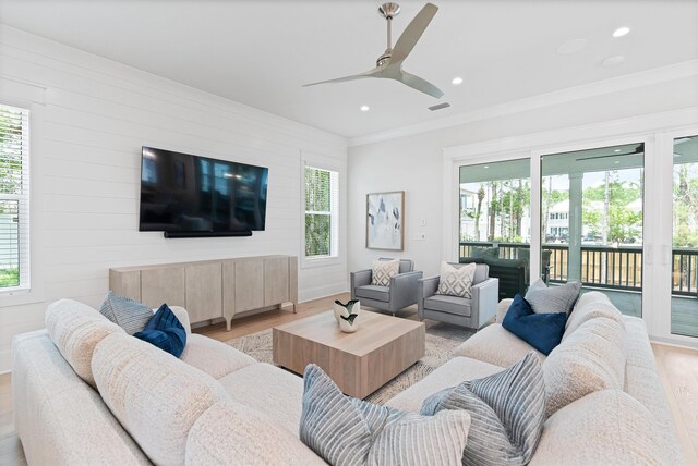 living room featuring ceiling fan, a healthy amount of sunlight, and light hardwood / wood-style flooring