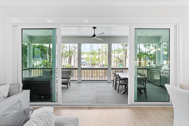 sunroom with plenty of natural light and ceiling fan