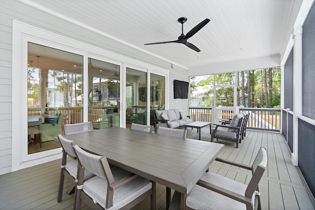 sunroom / solarium featuring ceiling fan