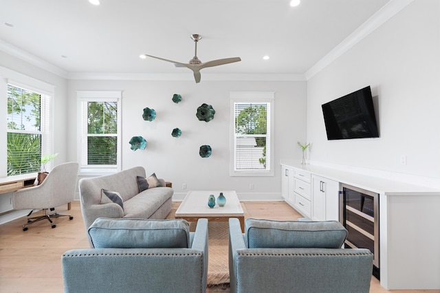 living room with ceiling fan, light hardwood / wood-style floors, and ornamental molding