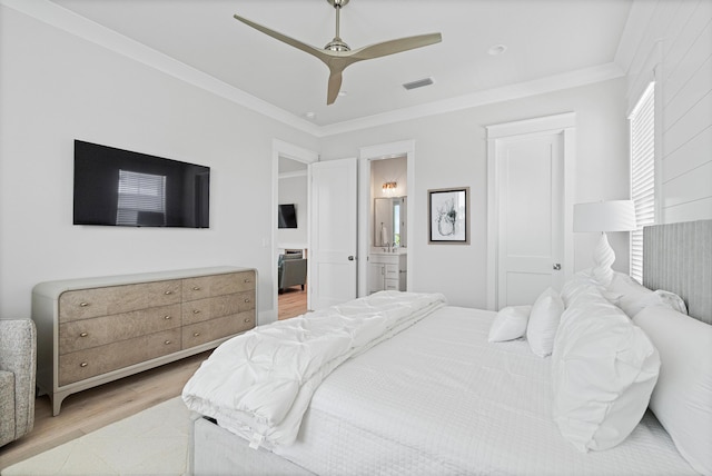 bedroom featuring connected bathroom, ceiling fan, light hardwood / wood-style flooring, and ornamental molding