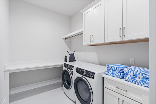 laundry room with washing machine and dryer and cabinets