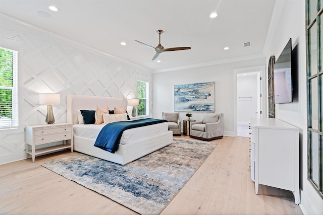 bedroom with ceiling fan, light hardwood / wood-style floors, and ornamental molding