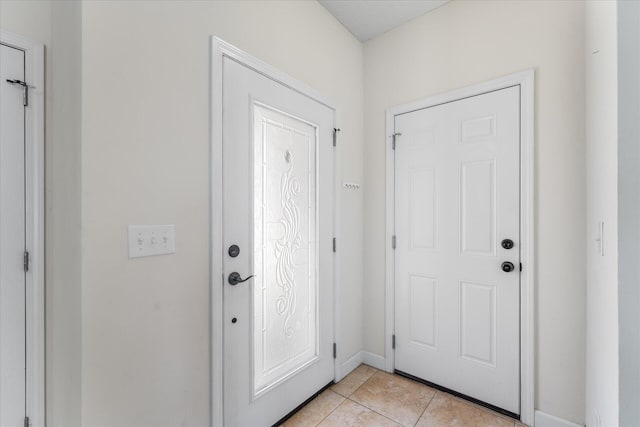 entryway with light tile patterned floors