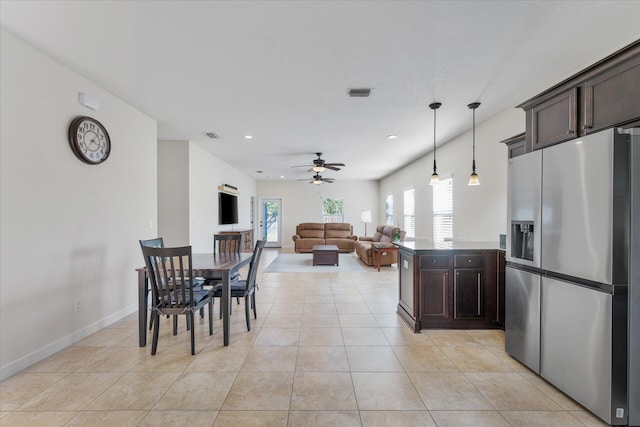 tiled dining area with ceiling fan and a healthy amount of sunlight