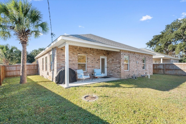 back of property featuring a patio and a lawn