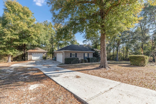 ranch-style home with an outbuilding and a garage