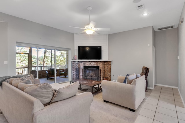 living room with ceiling fan, light tile patterned floors, and a fireplace