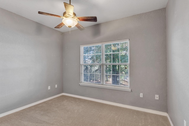 carpeted empty room with ceiling fan