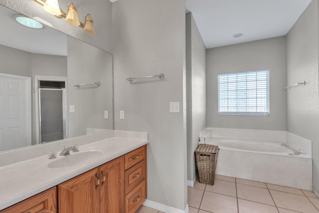 bathroom with tile patterned floors, vanity, and shower with separate bathtub