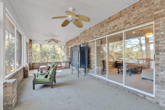 unfurnished sunroom featuring ceiling fan