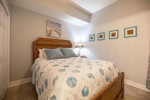 tiled bedroom featuring a closet