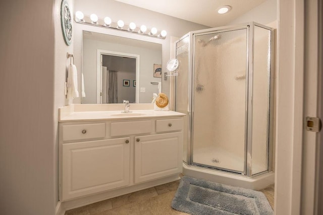 bathroom with tile patterned floors, vanity, and a shower with shower door