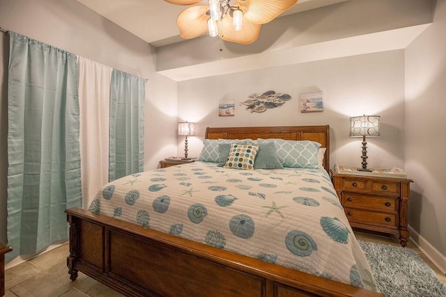 tiled bedroom featuring ceiling fan