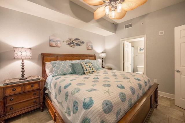 bedroom with ceiling fan, light tile patterned flooring, and ensuite bathroom