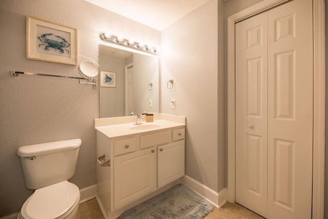 bathroom with tile patterned floors, vanity, and toilet