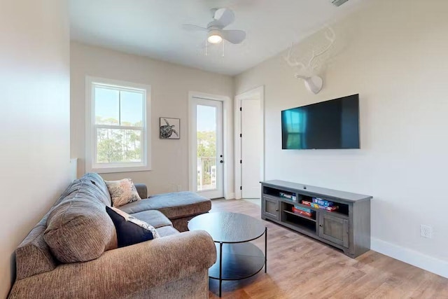 living room with ceiling fan, light hardwood / wood-style flooring, and a healthy amount of sunlight