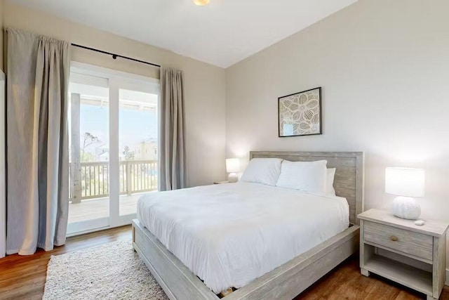 bedroom featuring access to exterior and hardwood / wood-style flooring