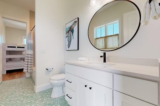 full bathroom with tile patterned flooring, vanity, shower / tub combo with curtain, and toilet