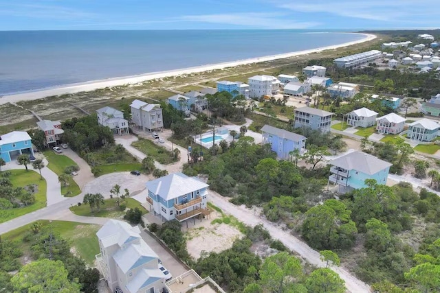 drone / aerial view featuring a beach view and a water view