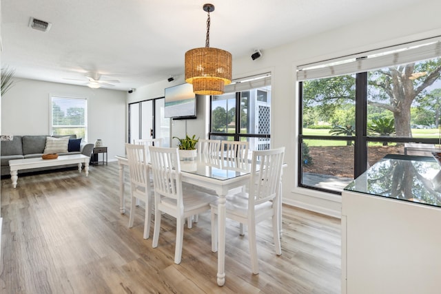 dining space featuring light hardwood / wood-style flooring and ceiling fan