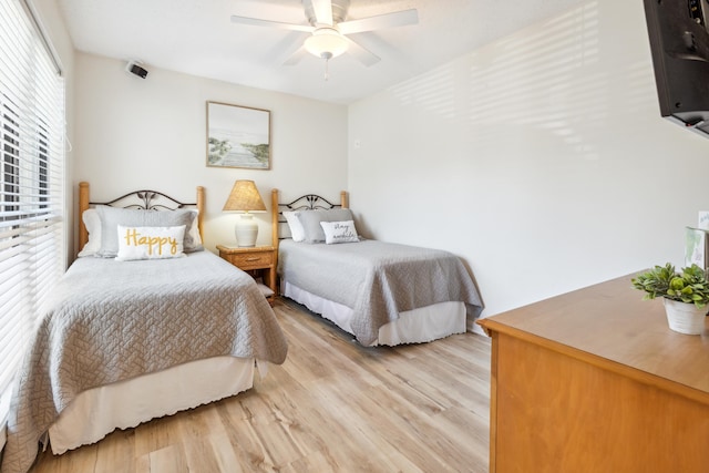 bedroom with light wood-type flooring and ceiling fan