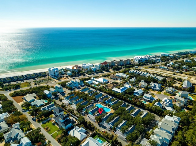 birds eye view of property with a water view and a view of the beach