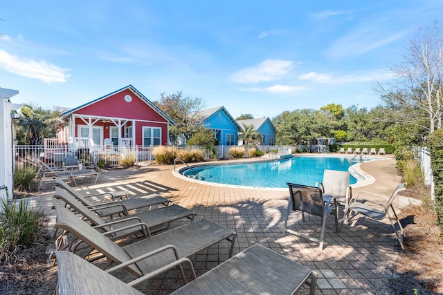 view of pool featuring a patio area and an outbuilding