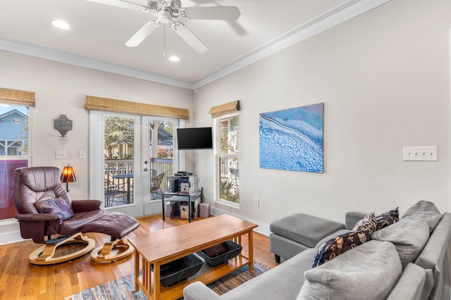 living room with hardwood / wood-style floors, ceiling fan, and crown molding