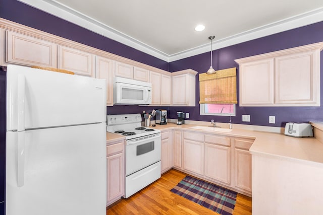 kitchen with sink, pendant lighting, white appliances, and light wood-type flooring