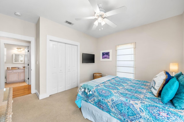 bedroom with ceiling fan, a closet, and light carpet