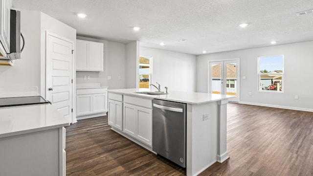 kitchen with stainless steel appliances, sink, a center island with sink, and white cabinets