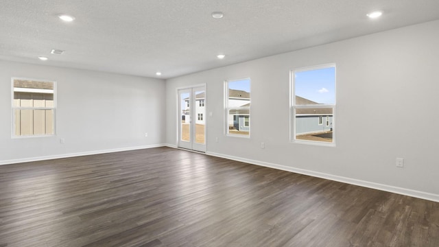 226 Laurel Hill St, Crestview, FL 32539 - empty room featuring plenty of natural light, dark wood-type flooring, baseboards, and a textured ceiling