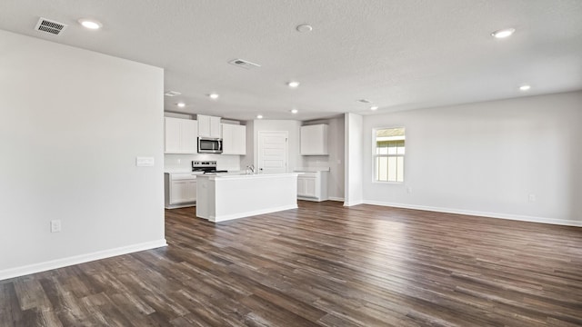 226 Laurel Hill St, Crestview, FL 32539 - unfurnished living room featuring baseboards, recessed lighting, a textured ceiling, visible vents, and dark wood finished floors