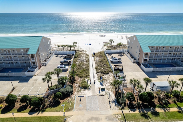 bird's eye view featuring a view of the beach and a water view