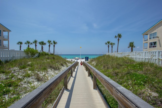 dock area with a beach view and a water view