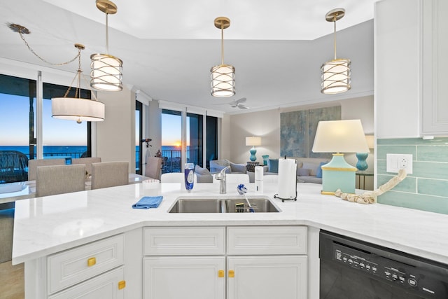 kitchen featuring dishwasher, backsplash, white cabinets, sink, and decorative light fixtures