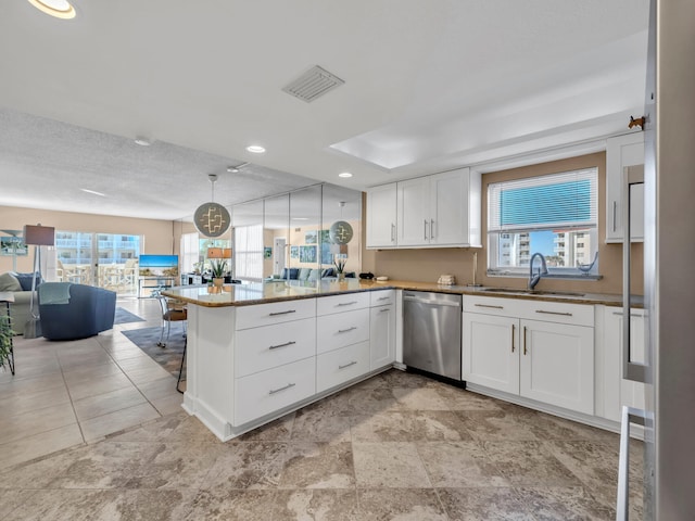 kitchen with stainless steel dishwasher, white cabinets, kitchen peninsula, and pendant lighting